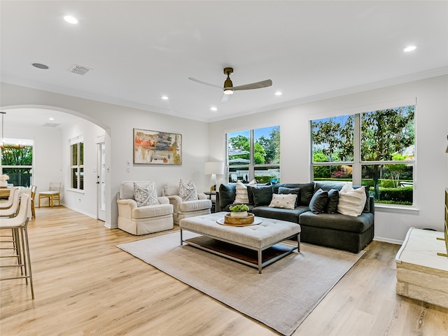 living room featuring ceiling fan, light hardwood / wood-style flooring, and crown molding