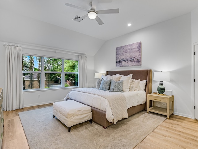 bedroom with ceiling fan, light hardwood / wood-style floors, and lofted ceiling