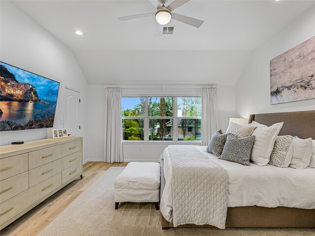 bedroom featuring light hardwood / wood-style floors, ceiling fan, and lofted ceiling