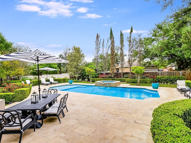 view of pool with an in ground hot tub and a patio