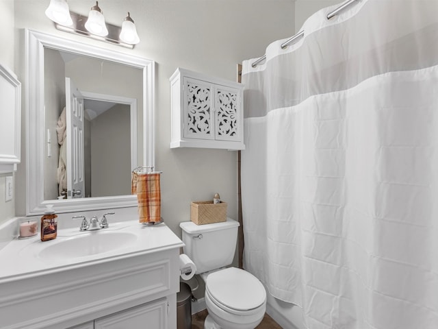 full bathroom featuring vanity, shower / bath combination with curtain, and toilet