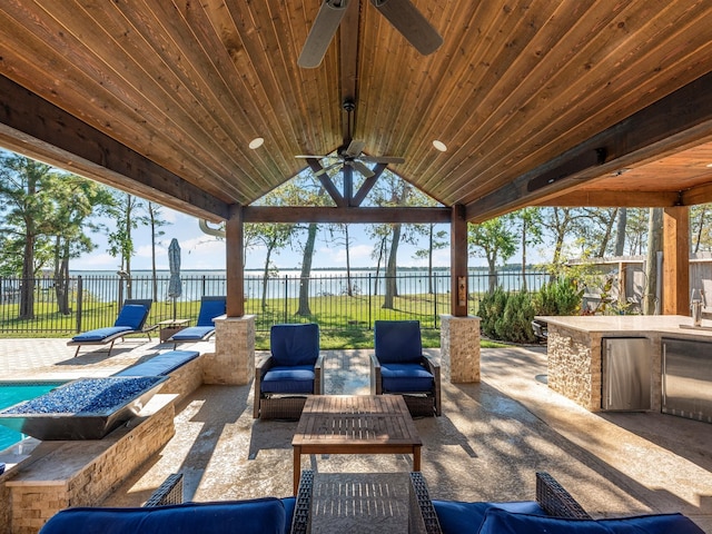 view of patio / terrace featuring a gazebo, outdoor lounge area, ceiling fan, and a water view