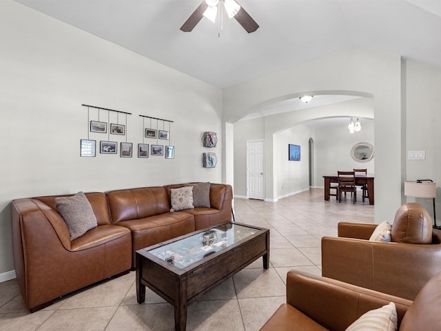 living room with ceiling fan, lofted ceiling, and light tile patterned floors