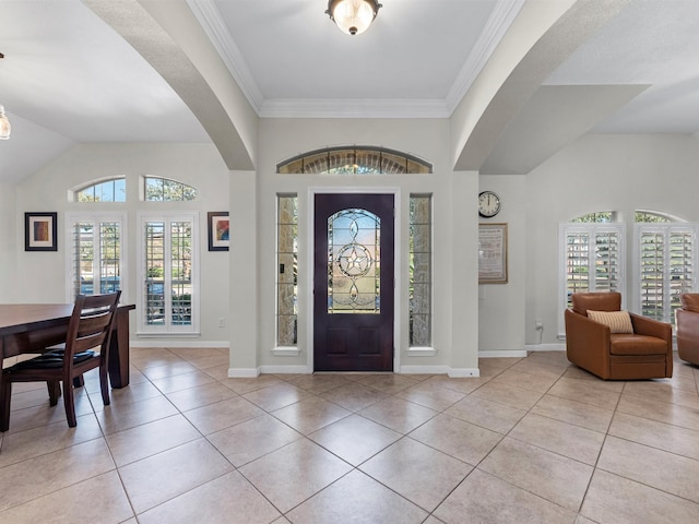 entrance foyer featuring a healthy amount of sunlight, light tile patterned flooring, and ornamental molding