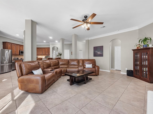 living room featuring ceiling fan, light tile patterned floors, and crown molding