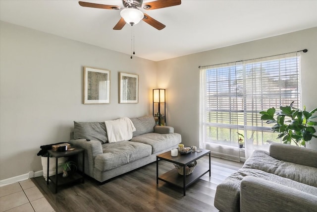 living room featuring light wood-type flooring, ceiling fan, and a healthy amount of sunlight