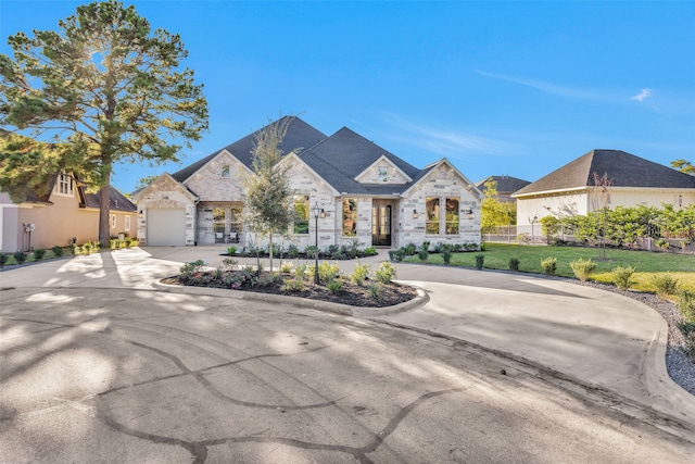 view of front of property featuring a garage and a front lawn