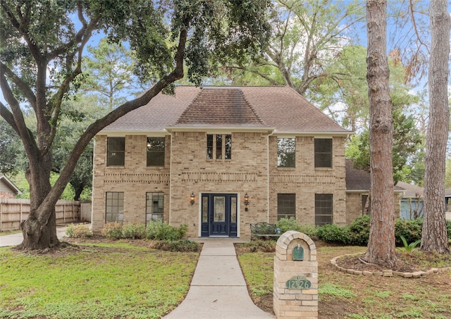 view of front of house featuring a front yard and french doors