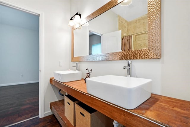 bathroom featuring wood-type flooring, vanity, and walk in shower