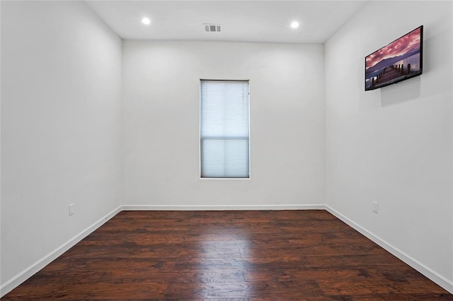 unfurnished room with dark wood-type flooring