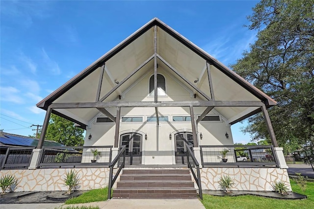 view of front of house featuring a porch and french doors