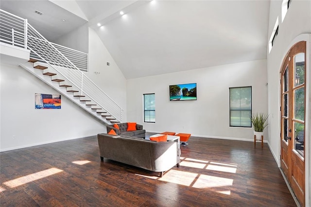 living room with dark hardwood / wood-style flooring and high vaulted ceiling