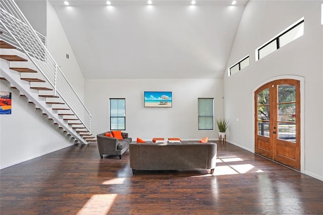 living room featuring french doors, dark hardwood / wood-style flooring, and a high ceiling