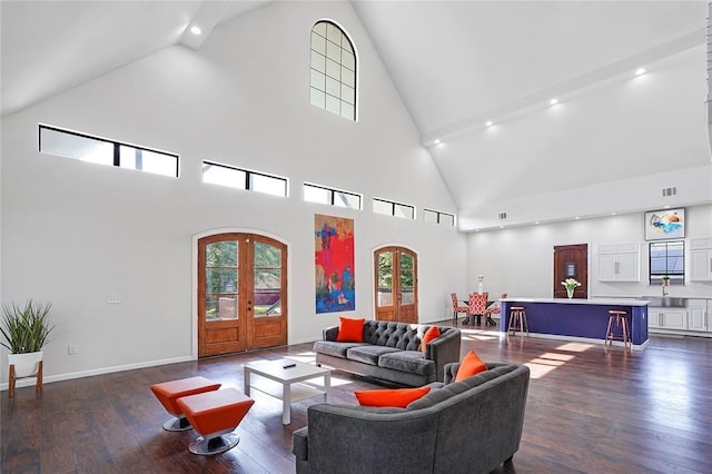 living room featuring dark hardwood / wood-style flooring, high vaulted ceiling, and french doors