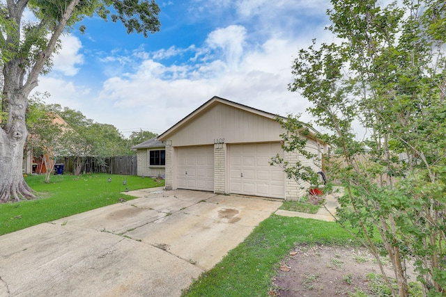 view of home's exterior with a garage and a yard