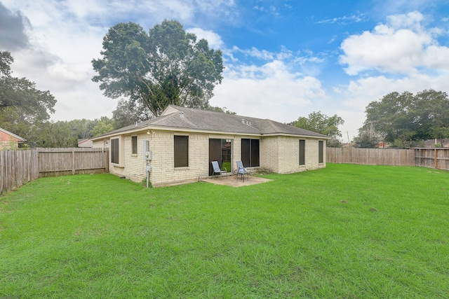 back of property featuring a lawn and a patio