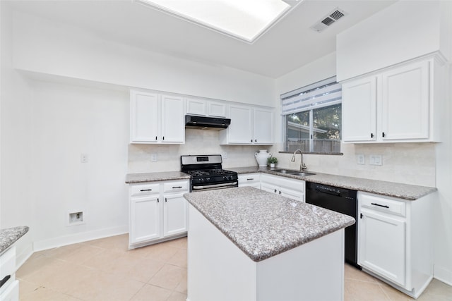 kitchen with stainless steel gas stove, a center island, white cabinetry, and sink