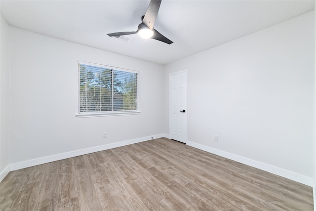 empty room with ceiling fan and light hardwood / wood-style floors