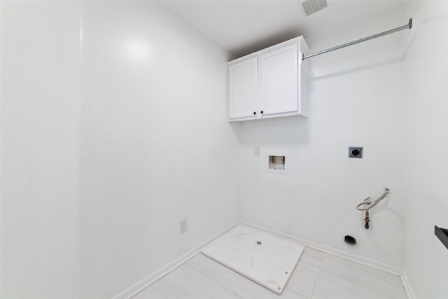 washroom featuring cabinets, washer hookup, hookup for a gas dryer, and electric dryer hookup