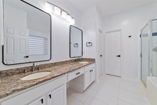 bathroom with tile patterned flooring, vanity, and a shower with shower door