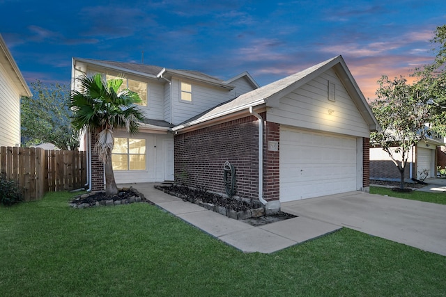 view of front of property featuring a lawn and a garage