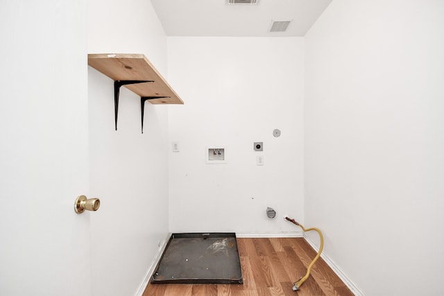 laundry area with washer hookup, light hardwood / wood-style floors, and electric dryer hookup