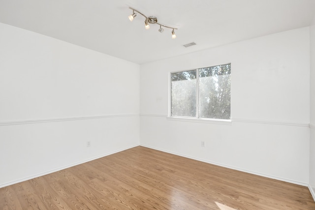 spare room featuring light hardwood / wood-style floors