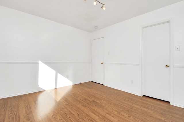 unfurnished room featuring hardwood / wood-style flooring