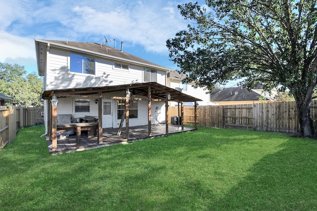 rear view of house with a lawn, central AC, and a patio area