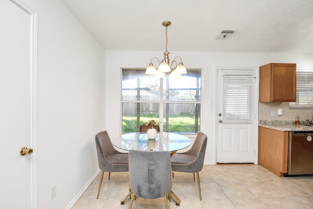 tiled dining room with a notable chandelier