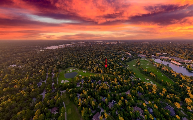 aerial view at dusk featuring a water view