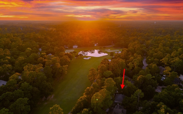 aerial view at dusk featuring a water view