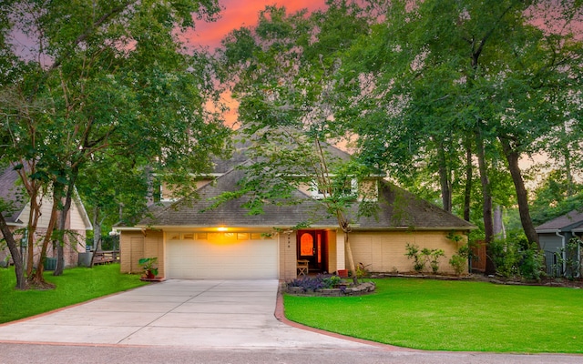 view of front of property with a yard and a garage