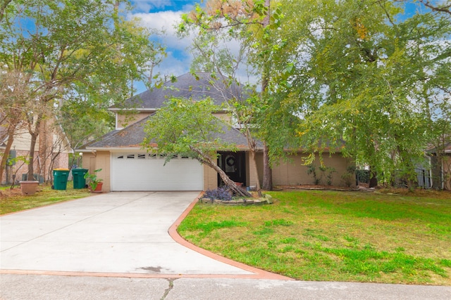 view of front of house featuring a garage and a front lawn