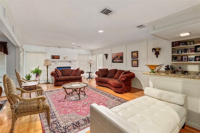 living room featuring light wood-type flooring and plenty of natural light