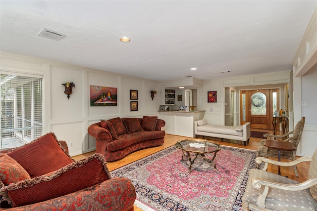 living room featuring wood-type flooring and a textured ceiling