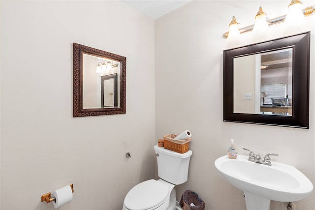 bathroom featuring toilet and sink