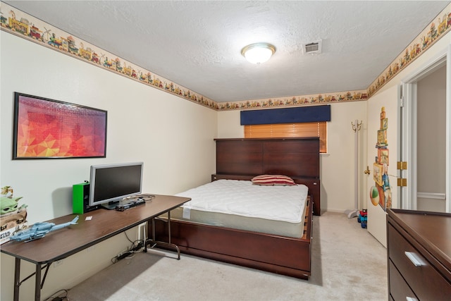 bedroom featuring light colored carpet and a textured ceiling