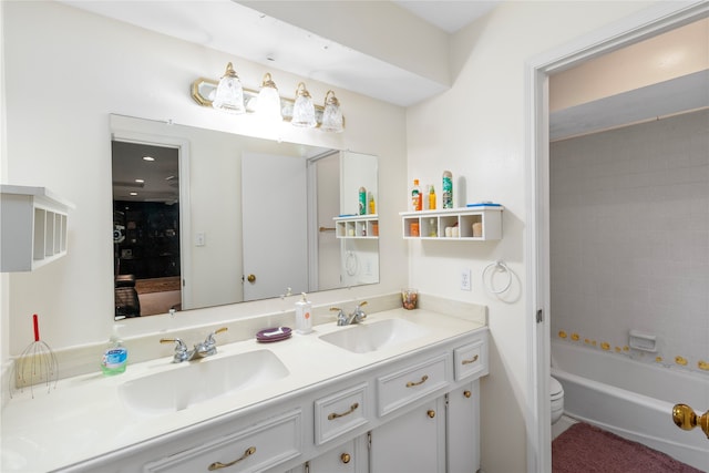 full bathroom featuring vanity, toilet, and tiled shower / bath