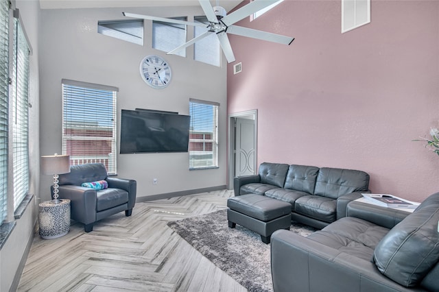 living room with light parquet floors, high vaulted ceiling, and ceiling fan