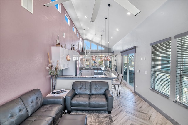 living room featuring a wealth of natural light, light parquet flooring, and high vaulted ceiling