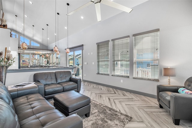 living room with ceiling fan, a high ceiling, and light parquet flooring