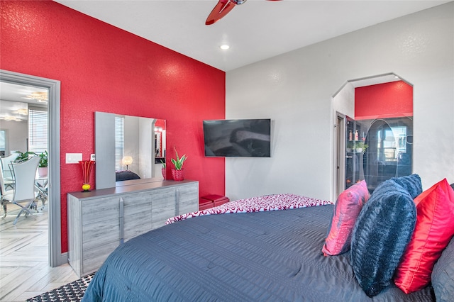 bedroom with light parquet flooring and ceiling fan