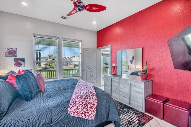 bedroom featuring multiple windows and ceiling fan