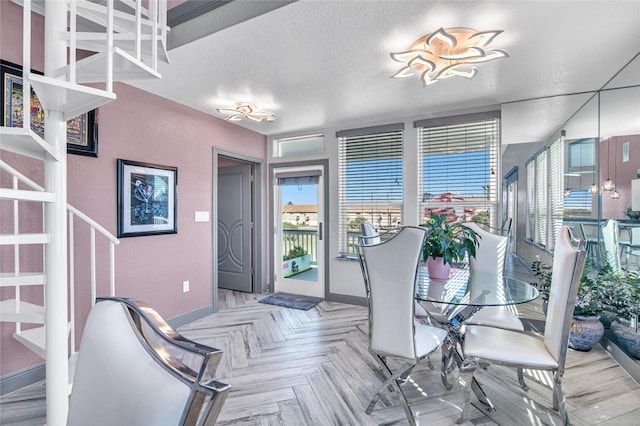 3709 Rice St, Galveston, TX 77554 - dining area with baseboards and a textured ceiling