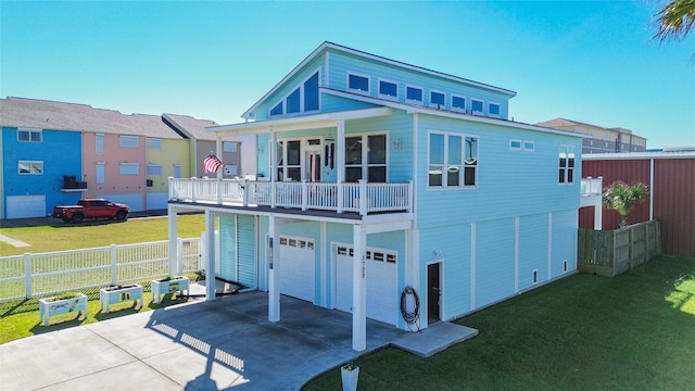 3709 Rice St, Galveston, TX 77554 - rear view of property with concrete driveway, a balcony, and an attached garage