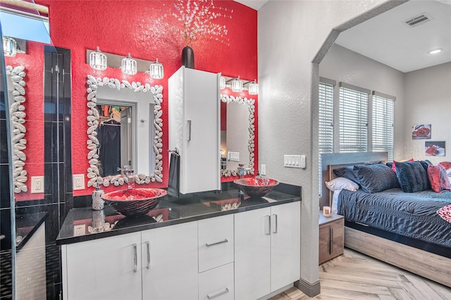 3709 Rice St, Galveston, TX 77554 - ensuite bathroom featuring double vanity and a textured wall