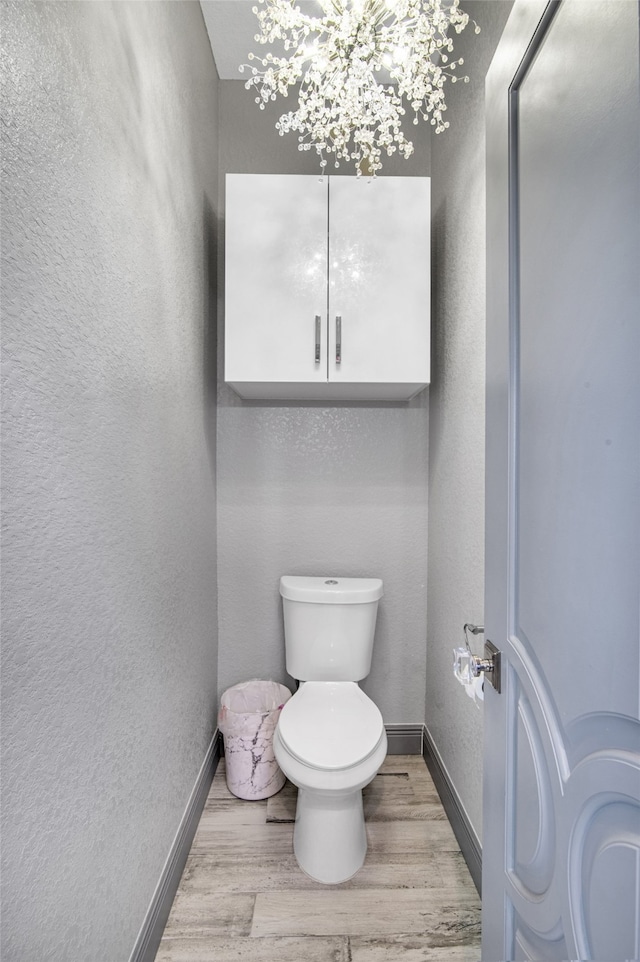 bathroom featuring hardwood / wood-style floors and toilet