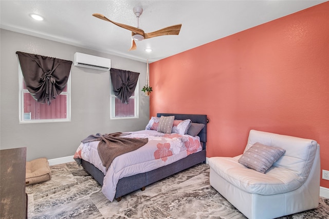 bedroom featuring a wall mounted air conditioner and ceiling fan