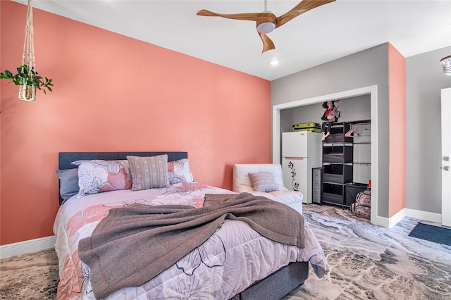 bedroom featuring white refrigerator and ceiling fan